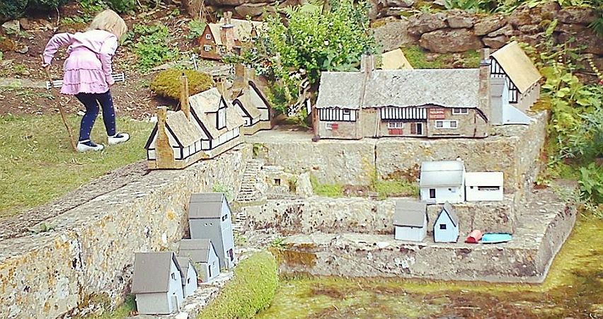 A young visitor explores the miniature houses in the garden of Snowshill Manor. Picture by Peter Dixon.